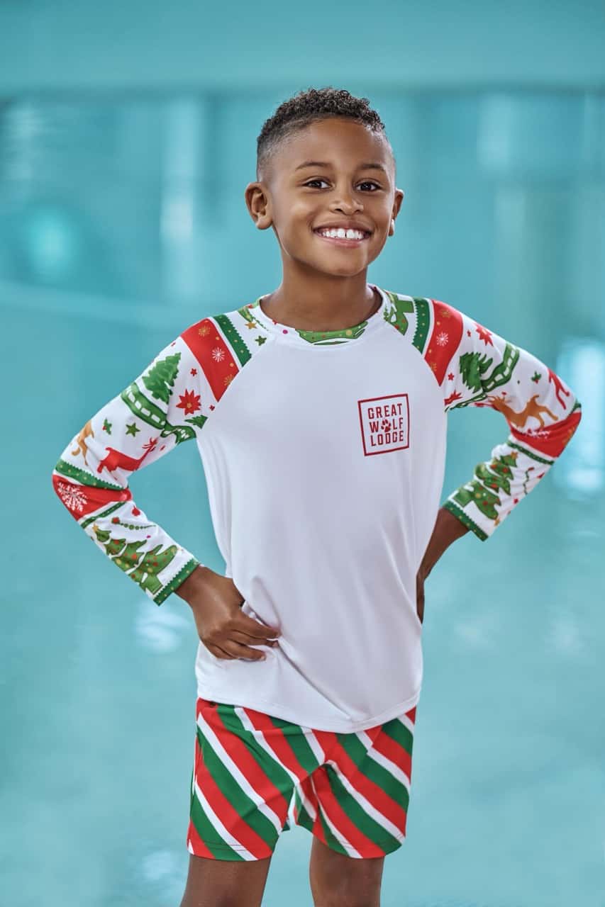 a boy wearing a christmas themed swimwear